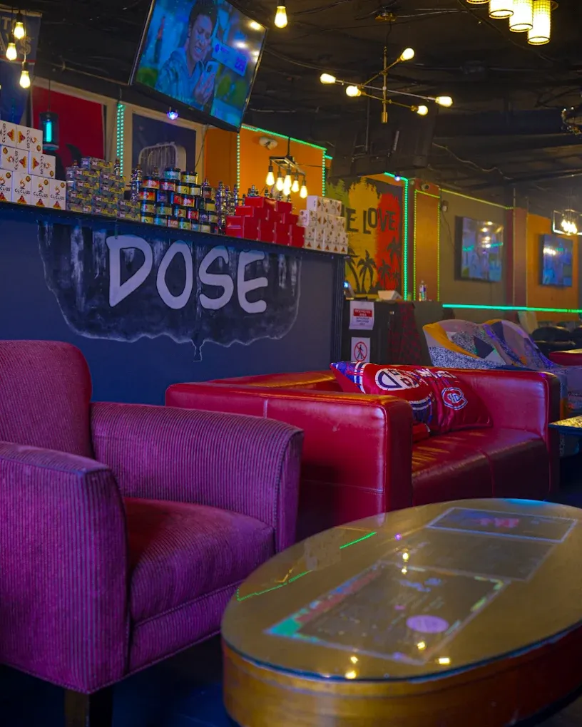 The hand-painted DOSE bar at Dose Shisha, with red leather couches and shisha flavour boxes on the counter