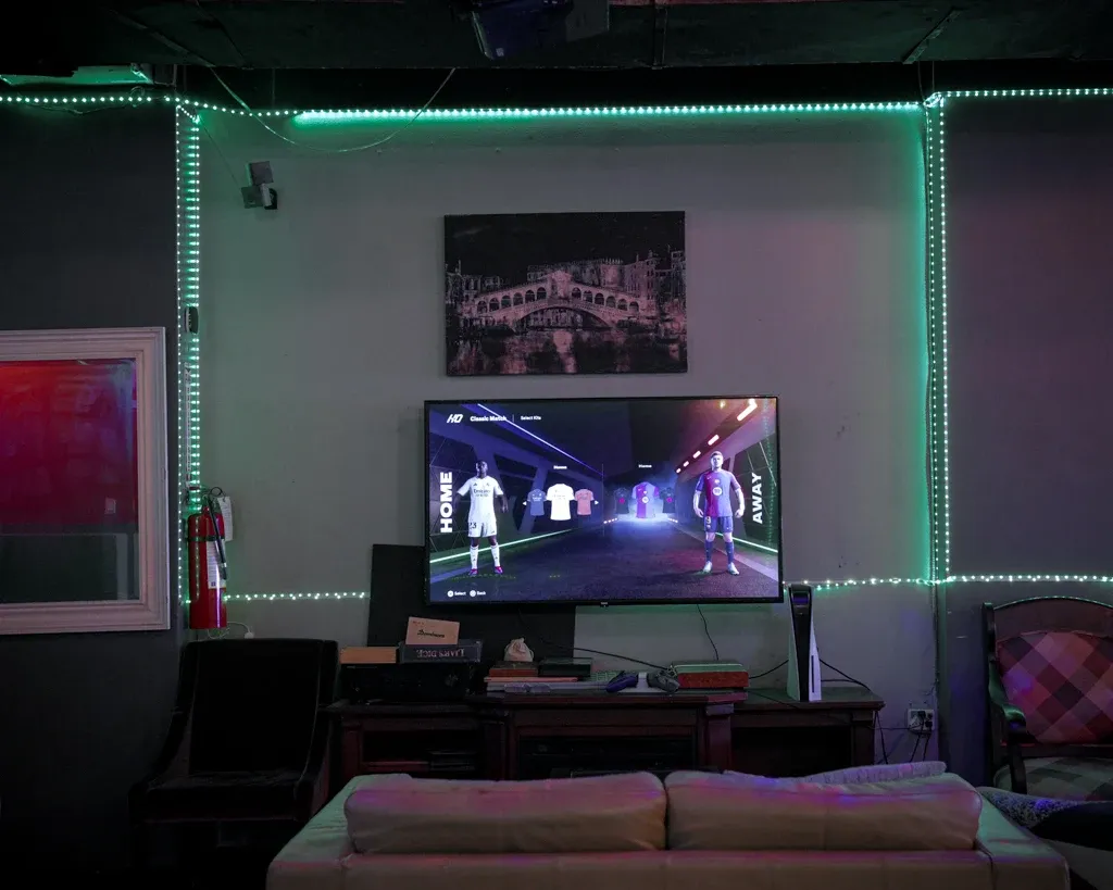 Neon-lit games corner at Dose Shisha with FIFA on the big screen